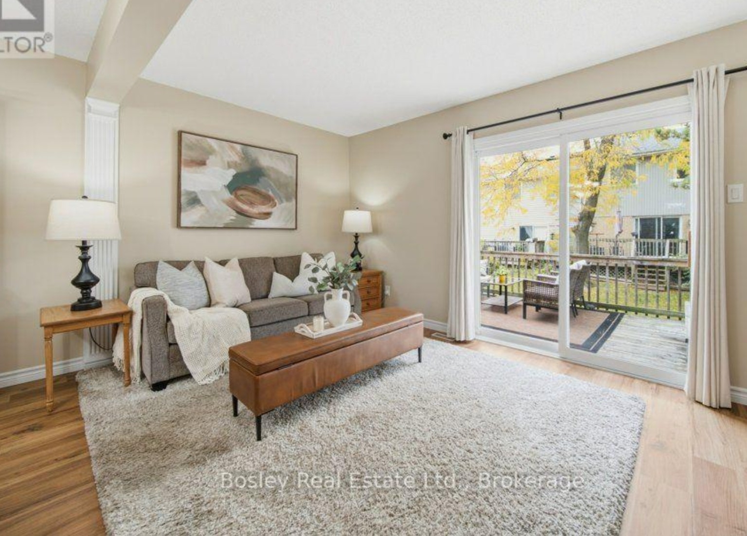 After: neutral living room with fresh art, styled cushions, and a bright open layout